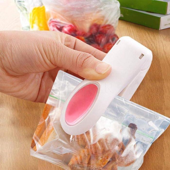 Hand using a portable mini sealing machine to close a plastic bag, food preservation.
