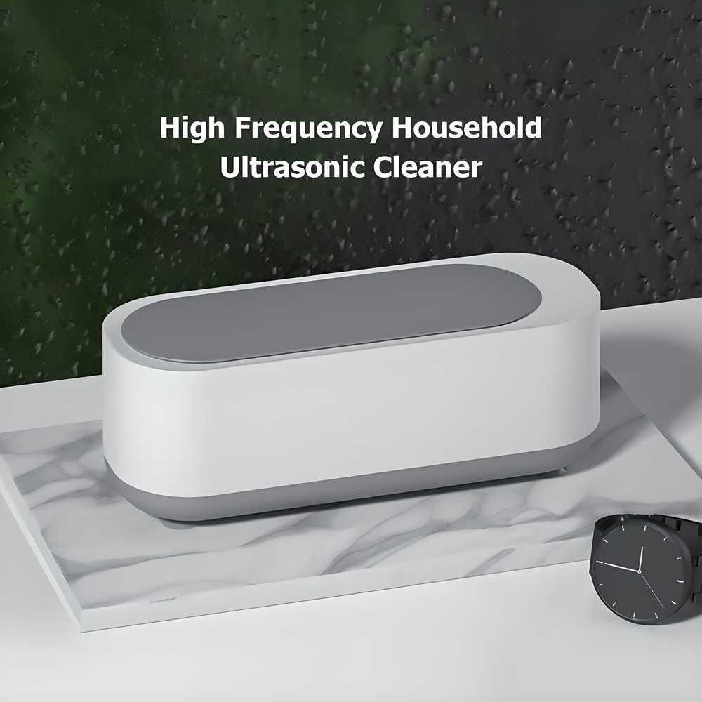 High-frequency household ultrasonic cleaner for jewelry on display. Cleans efficiently with ultrasonic waves, compact size.